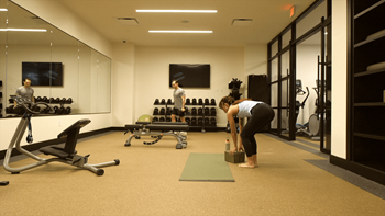 A gym with a person doing a yoga pose.